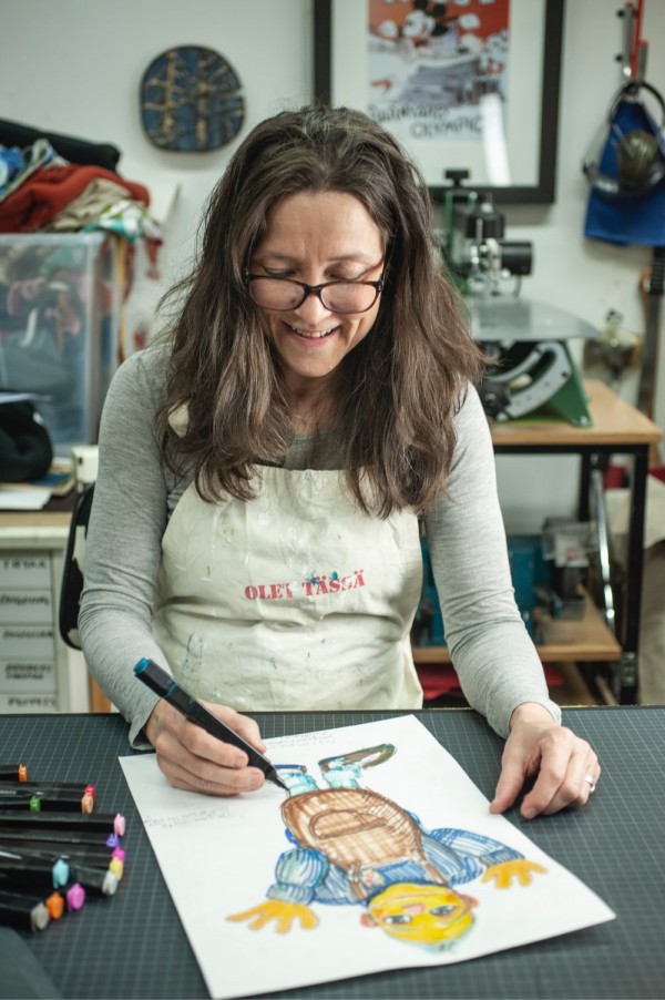 Tiina is drawing a puppet figure on a paper