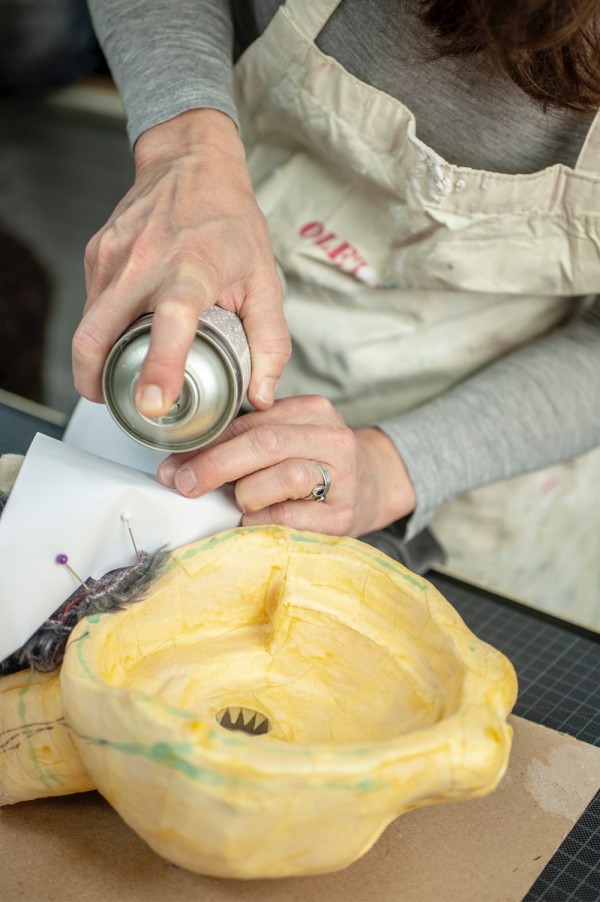 Tiina is gluing faux fur to a puppet