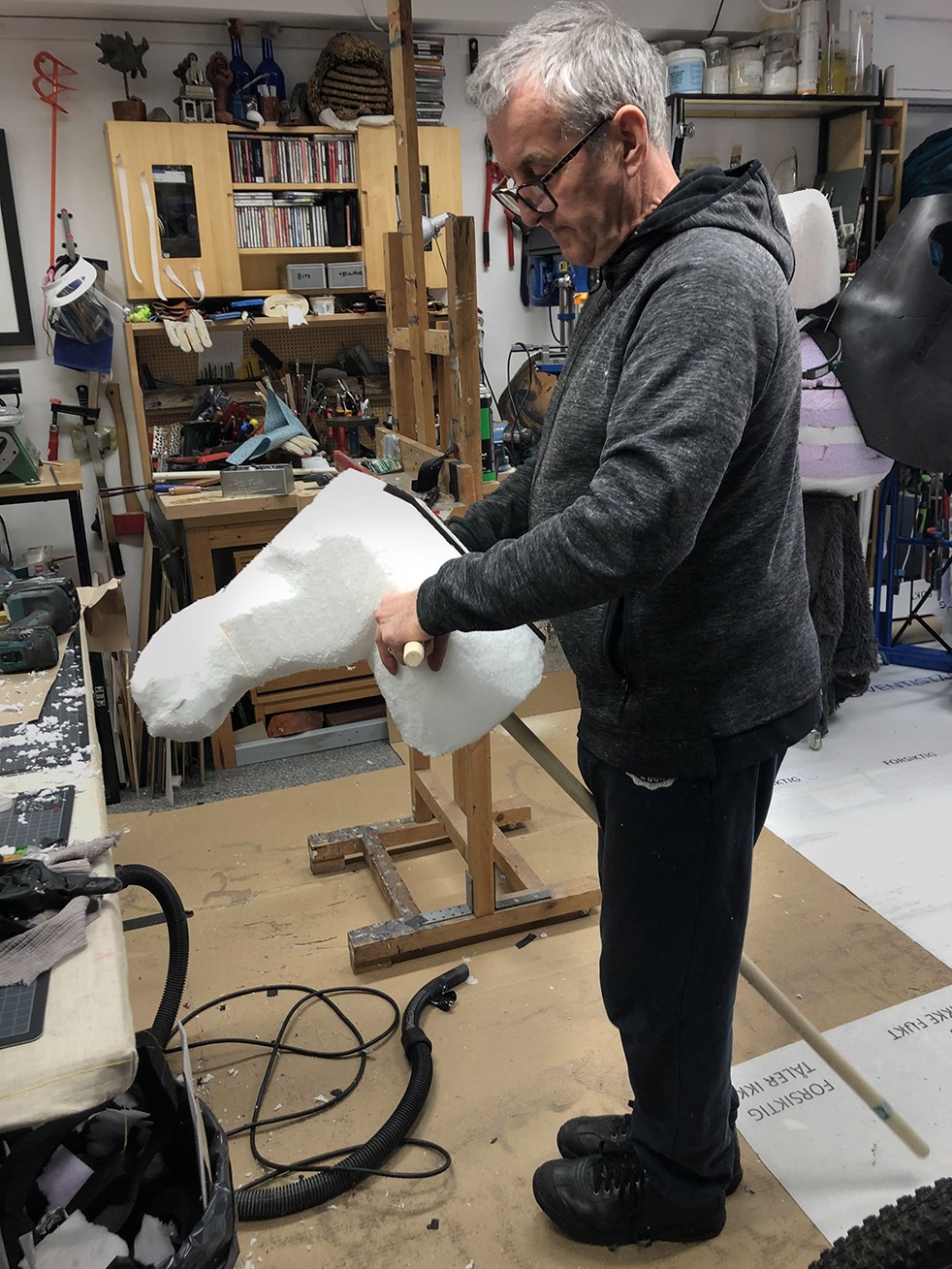 Sean holding a white foam hobby donkey in profile.